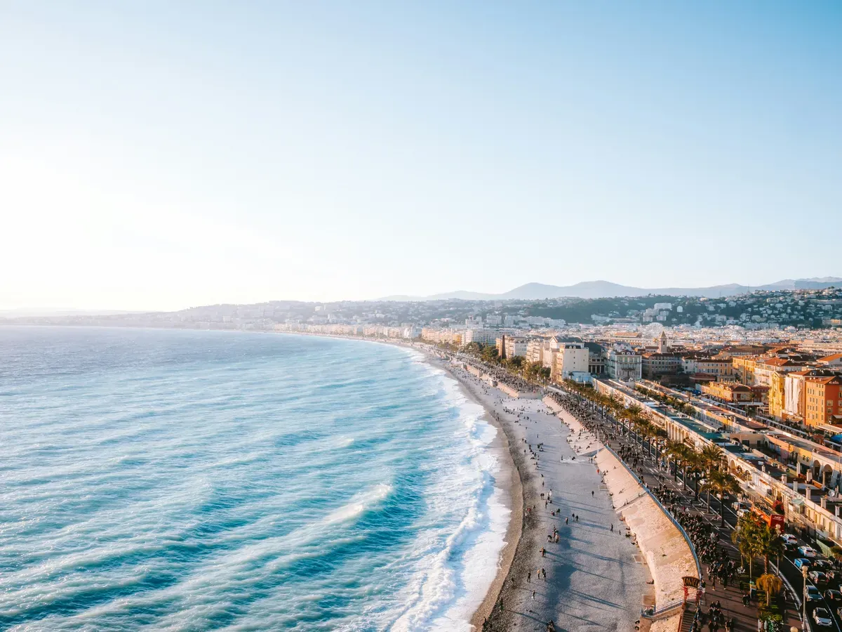 Il lungomare di Nizza, con le onde e la città sullo sfondo